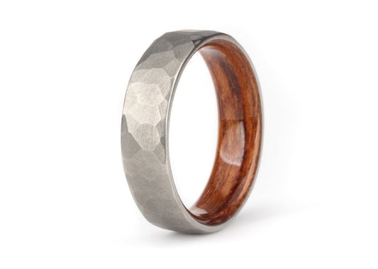 Hand-ground faceted "Boseman" titanium ring with polished bentwood interior white background