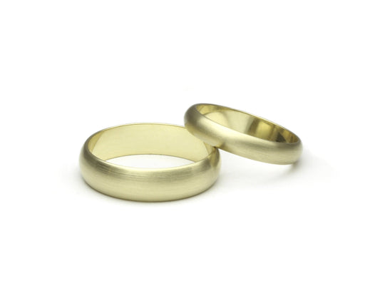 14k yellow gold classic domed couples ring set on a white background